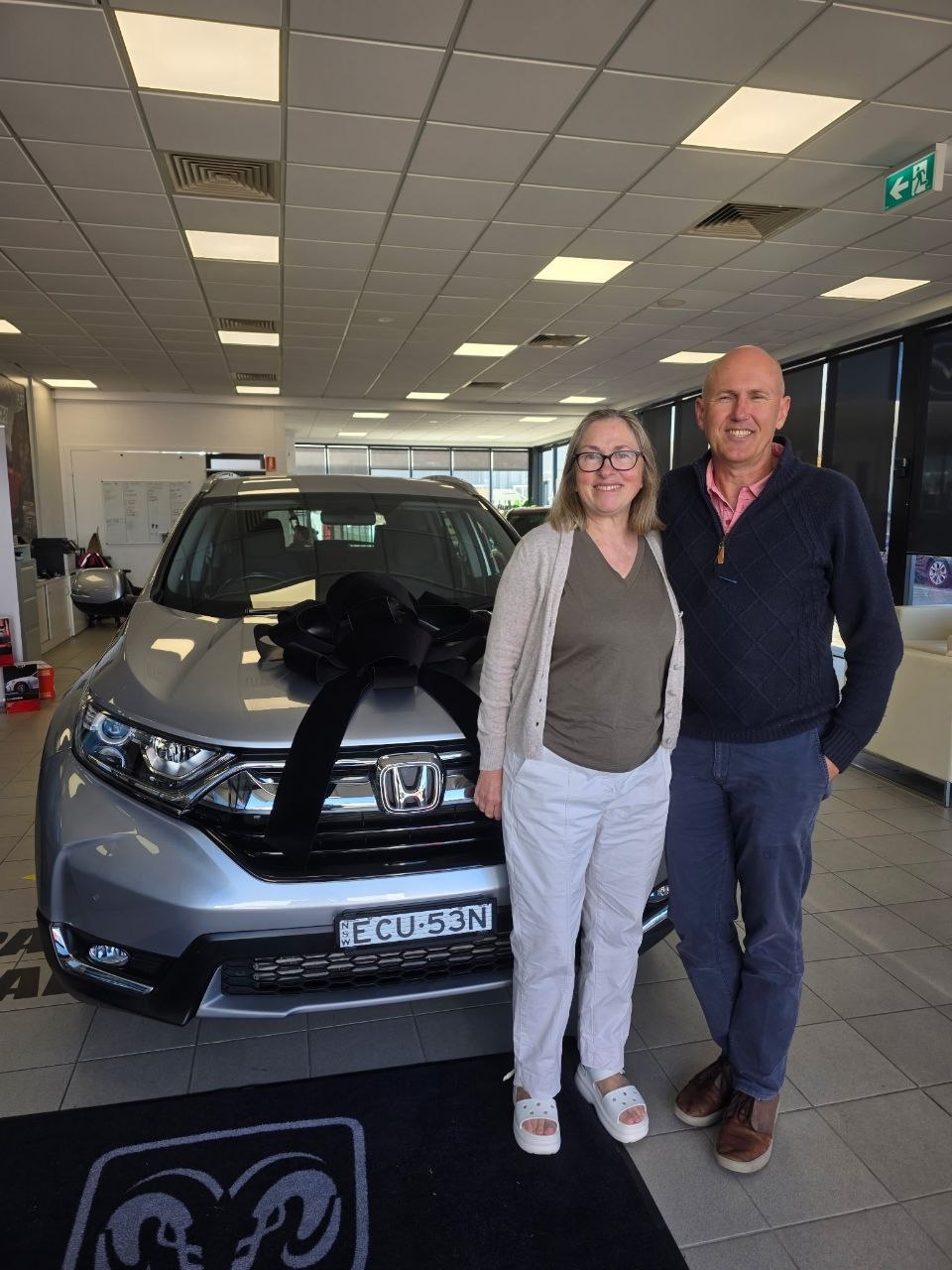 Mum and Dad with the bow-wrapped car
